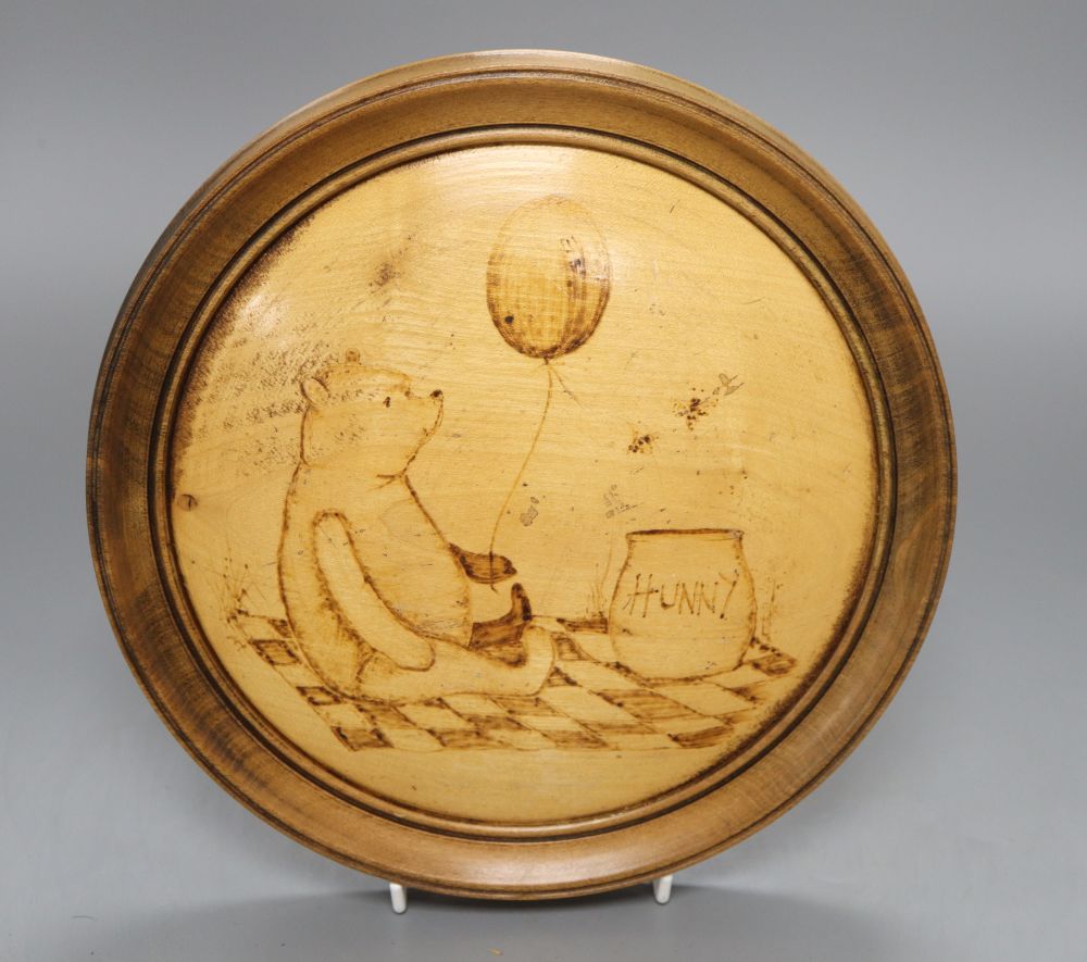 A poker work plaque of Winnie the Pooh, diameter 24.5cm